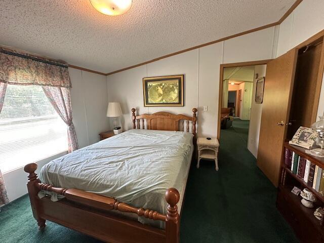 10830 Voris Rd, Logan, OH 43138 - carpeted bedroom featuring lofted ceiling, ornamental molding, and a textured ceiling