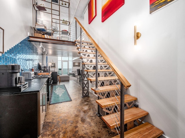 60 E Spring St Unit 214, Columbus, OH 43215 - staircase with concrete flooring and a high ceiling