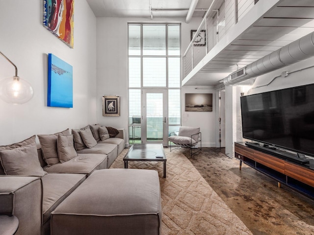 60 E Spring St Unit 214, Columbus, OH 43215 - living room with finished concrete flooring and a towering ceiling