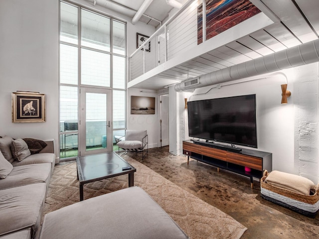 60 E Spring St Unit 214, Columbus, OH 43215 - living area featuring concrete flooring, a towering ceiling, and healthy amount of natural light