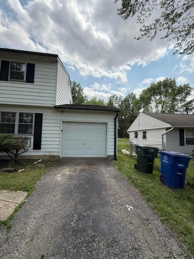 3391 Compton Dr, Columbus, OH 43219 - view of side of property featuring asphalt driveway and a garage