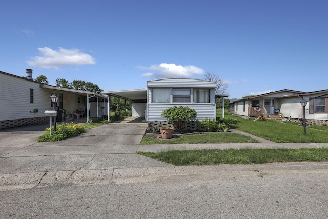 4455 Janice Marie Blvd, Obetz, OH 43207 - manufactured / mobile home featuring driveway, a carport, and a front lawn