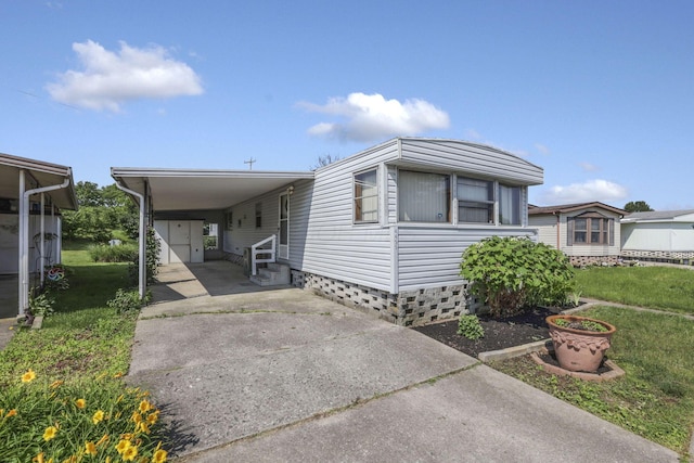 4455 Janice Marie Blvd, Obetz, OH 43207 - manufactured / mobile home with entry steps, driveway, a front lawn, and a carport