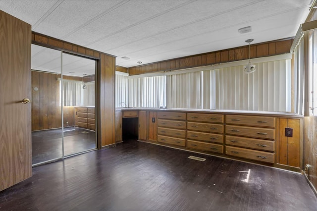4455 Janice Marie Blvd, Obetz, OH 43207 - empty room with dark wood-style flooring, wood walls, and a textured ceiling