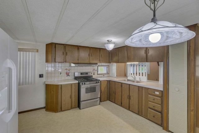 4455 Janice Marie Blvd, Obetz, OH 43207 - kitchen featuring gas range, brown cabinets, light countertops, light colored carpet, and a textured ceiling