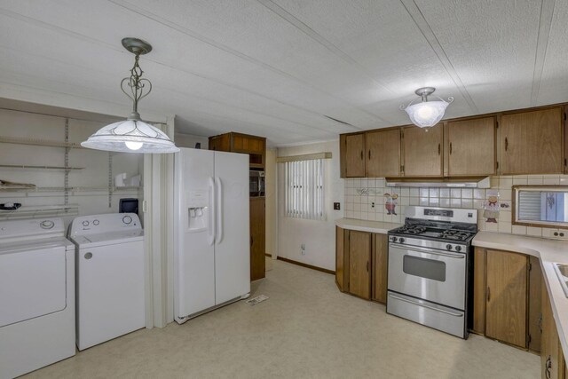 4455 Janice Marie Blvd, Obetz, OH 43207 - kitchen with stainless steel gas range oven, white refrigerator with ice dispenser, separate washer and dryer, brown cabinetry, and light countertops