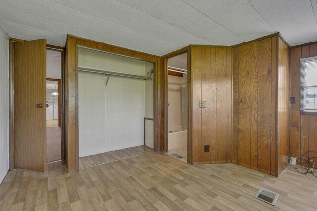 4455 Janice Marie Blvd, Obetz, OH 43207 - unfurnished bedroom with wood finished floors, wooden walls, and a closet