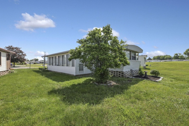 4455 Janice Marie Blvd, Obetz, OH 43207 - view of side of property featuring a lawn and a sunroom