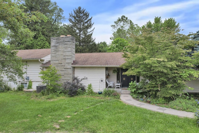 285 E Broad St, Pataskala, OH 43062 - view of front of house featuring a front lawn and a chimney