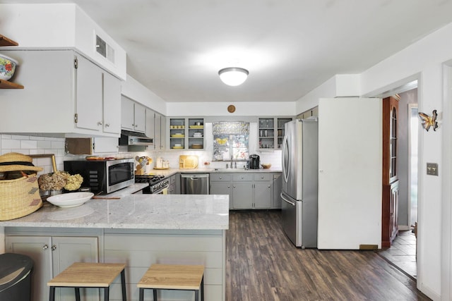 285 E Broad St, Pataskala, OH 43062 - kitchen featuring appliances with stainless steel finishes, a peninsula, exhaust hood, and backsplash