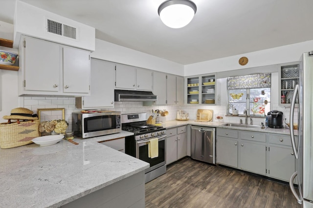 285 E Broad St, Pataskala, OH 43062 - kitchen featuring stainless steel appliances, under cabinet range hood, gray cabinetry, and decorative backsplash