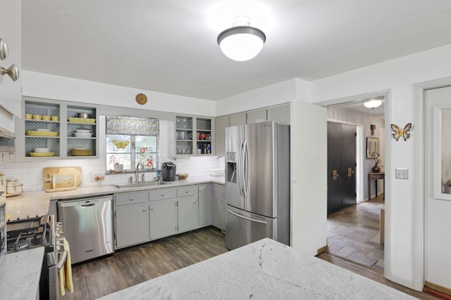 285 E Broad St, Pataskala, OH 43062 - kitchen featuring appliances with stainless steel finishes, tasteful backsplash, light stone countertops, and dark wood finished floors