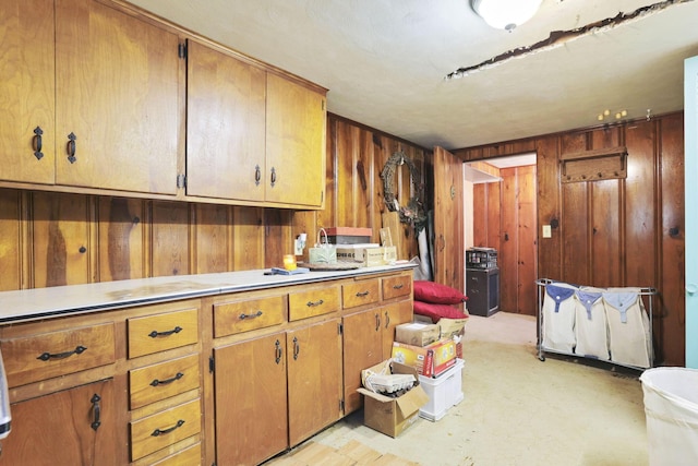 285 E Broad St, Pataskala, OH 43062 - kitchen featuring wooden walls, brown cabinetry, and light countertops