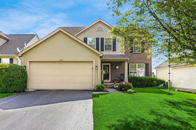 9188 Colonial Commons Dr, Columbus, OH 43240 - traditional-style home featuring asphalt driveway, an attached garage, brick siding, and a front yard