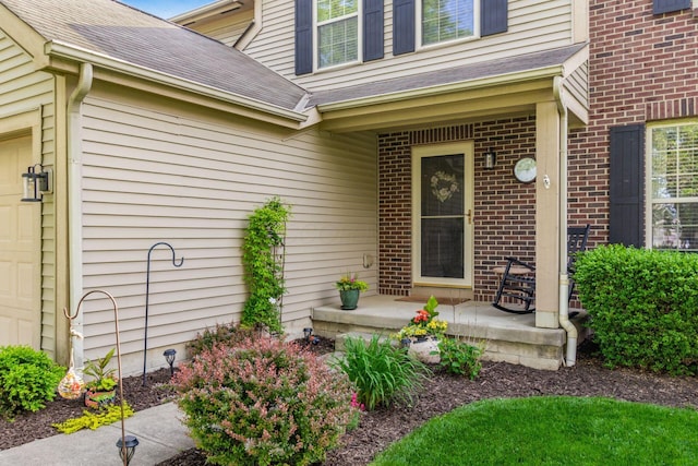 9188 Colonial Commons Dr, Columbus, OH 43240 - view of exterior entry featuring a shingled roof, brick siding, and covered porch