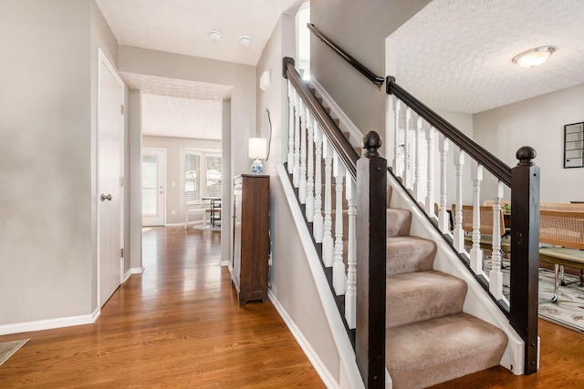 9188 Colonial Commons Dr, Columbus, OH 43240 - staircase with wood finished floors and a textured ceiling