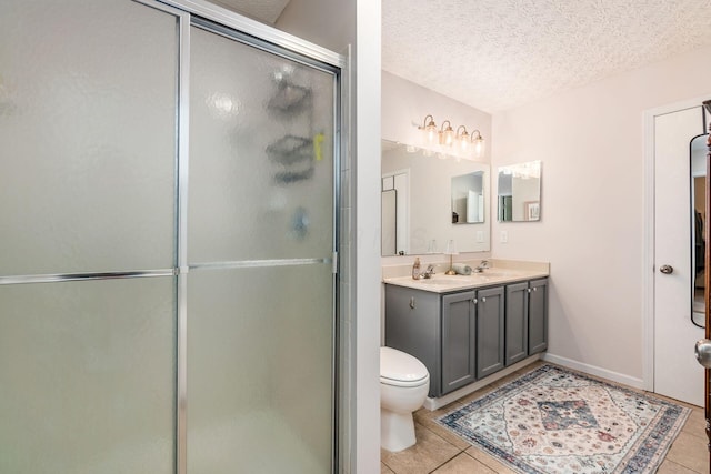 9188 Colonial Commons Dr, Columbus, OH 43240 - bathroom with tile patterned floors, a textured ceiling, double vanity, and a stall shower