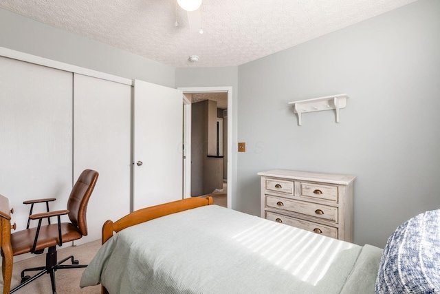 9188 Colonial Commons Dr, Columbus, OH 43240 - carpeted bedroom with a closet, a textured ceiling, and a ceiling fan