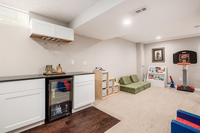 9188 Colonial Commons Dr, Columbus, OH 43240 - indoor dry bar with wine cooler, recessed lighting, and dark colored carpet