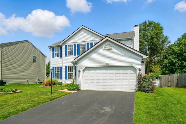 8578 Bivouac Pl, Galloway, OH 43119 - view of front facade with asphalt driveway, a garage, and a chimney