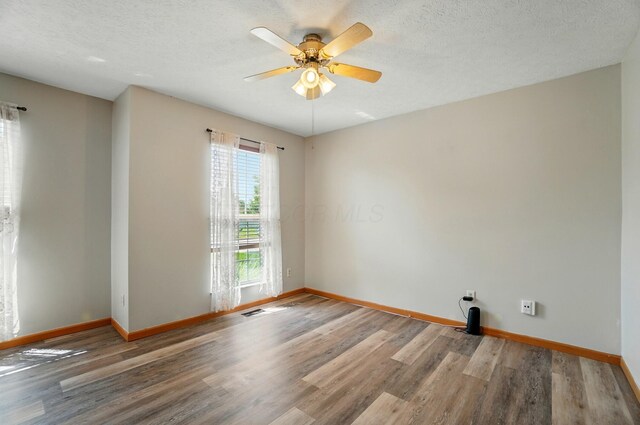 8578 Bivouac Pl, Galloway, OH 43119 - empty room featuring wood finished floors, ceiling fan, and a textured ceiling