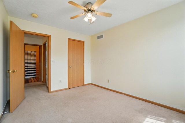 8578 Bivouac Pl, Galloway, OH 43119 - unfurnished bedroom with light colored carpet, ceiling fan, and a closet
