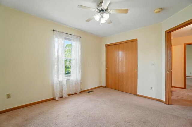 8578 Bivouac Pl, Galloway, OH 43119 - unfurnished bedroom featuring carpet, a closet, and a ceiling fan