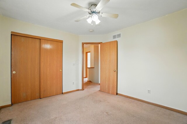 8578 Bivouac Pl, Galloway, OH 43119 - unfurnished bedroom with a closet, light carpet, and a ceiling fan