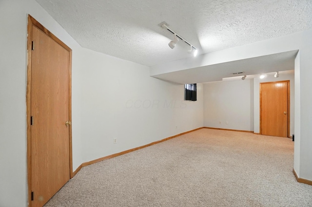 8578 Bivouac Pl, Galloway, OH 43119 - finished basement with rail lighting, a textured ceiling, and carpet