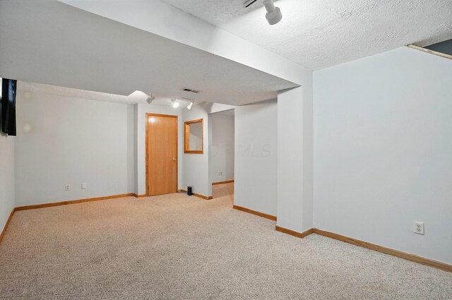 8578 Bivouac Pl, Galloway, OH 43119 - finished basement with light colored carpet, track lighting, and a textured ceiling