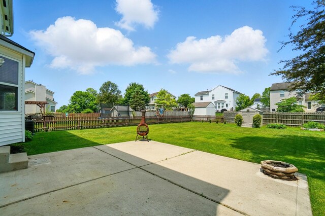 8578 Bivouac Pl, Galloway, OH 43119 - fenced backyard with a patio, an outdoor fire pit, and a residential view