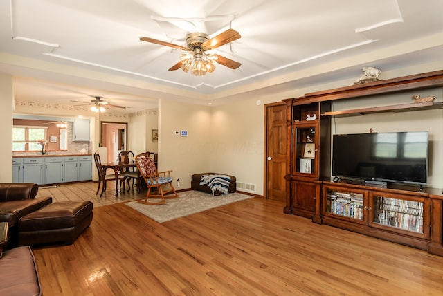 4005 Curtis Ave, Grove City, OH 43123 - living room featuring ceiling fan, light wood finished floors, and a raised ceiling