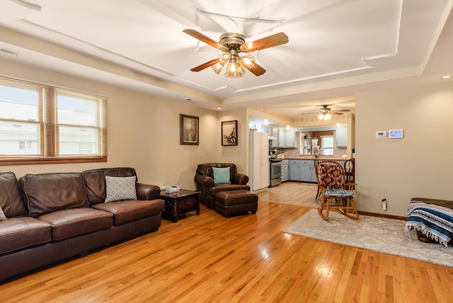 4005 Curtis Ave, Grove City, OH 43123 - living area featuring a raised ceiling, ceiling fan, and light wood-style floors