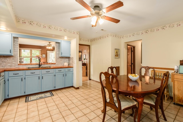 4005 Curtis Ave, Grove City, OH 43123 - kitchen featuring blue cabinetry, ceiling fan, butcher block counters, and decorative backsplash
