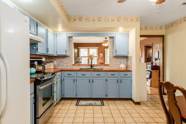 4005 Curtis Ave, Grove City, OH 43123 - kitchen featuring stainless steel range with electric stovetop, a ceiling fan, freestanding refrigerator, and blue cabinets