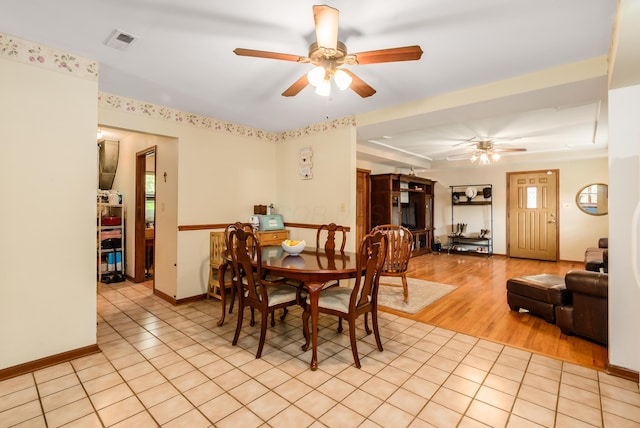 4005 Curtis Ave, Grove City, OH 43123 - dining area featuring a ceiling fan, a tray ceiling, light tile patterned flooring, and plenty of natural light