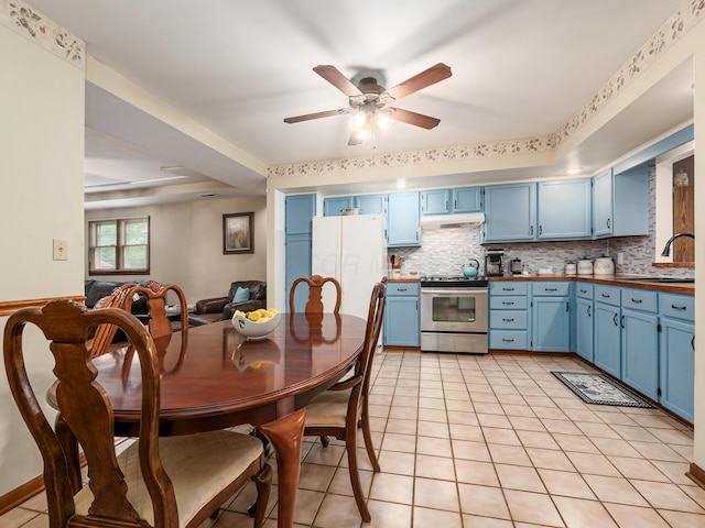 4005 Curtis Ave, Grove City, OH 43123 - kitchen with stainless steel electric range, blue cabinetry, freestanding refrigerator, under cabinet range hood, and backsplash