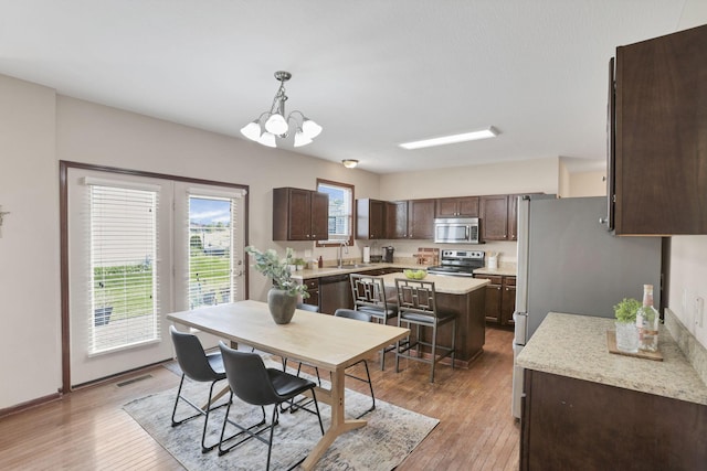 101 Stirling Way, Etna, OH 43062 - dining area with light wood finished floors and a chandelier