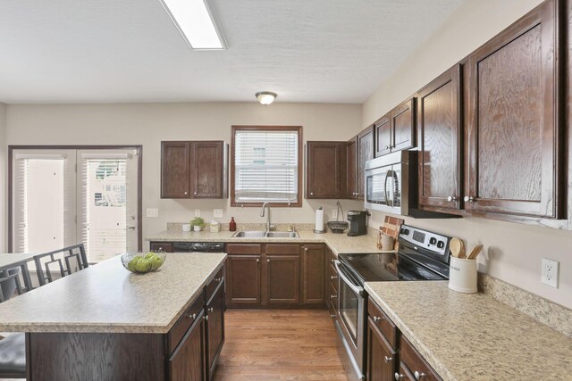 101 Stirling Way, Etna, OH 43062 - kitchen with appliances with stainless steel finishes, light countertops, and dark brown cabinets