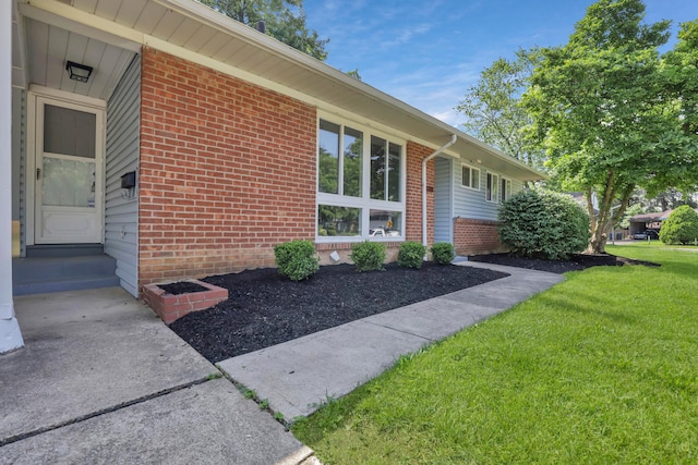 2870 Hamilton Ave, Columbus, OH 43224 - property entrance featuring brick siding and a yard