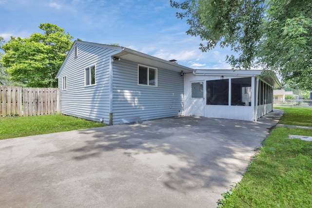 2870 Hamilton Ave, Columbus, OH 43224 - view of front of property with a sunroom, a patio, and driveway