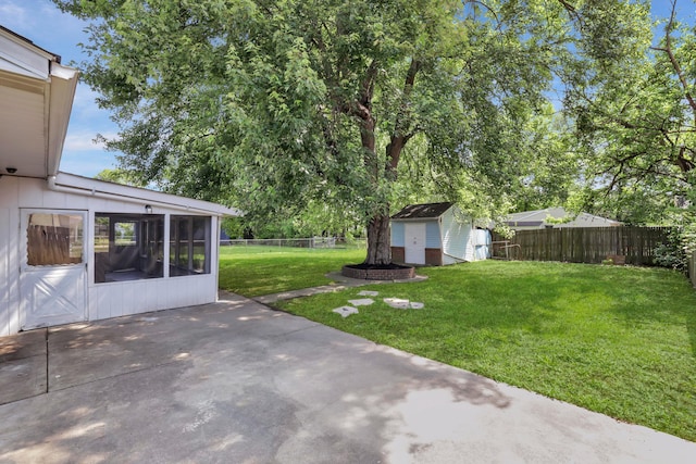 2870 Hamilton Ave, Columbus, OH 43224 - fenced backyard featuring a patio, a sunroom, and a storage unit