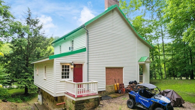 24000 State Route 180, Rockbridge, OH 43149 - rear view of house with a chimney