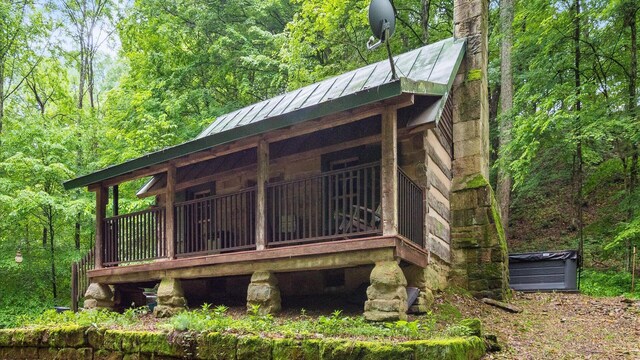24000 State Route 180, Rockbridge, OH 43149 - exterior space with a standing seam roof, a metal roof, and a view of trees