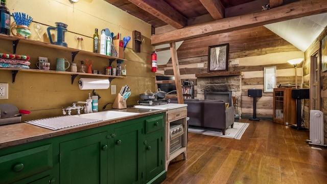 24000 State Route 180, Rockbridge, OH 43149 - kitchen with green cabinets, wooden walls, dark wood-style floors, and radiator