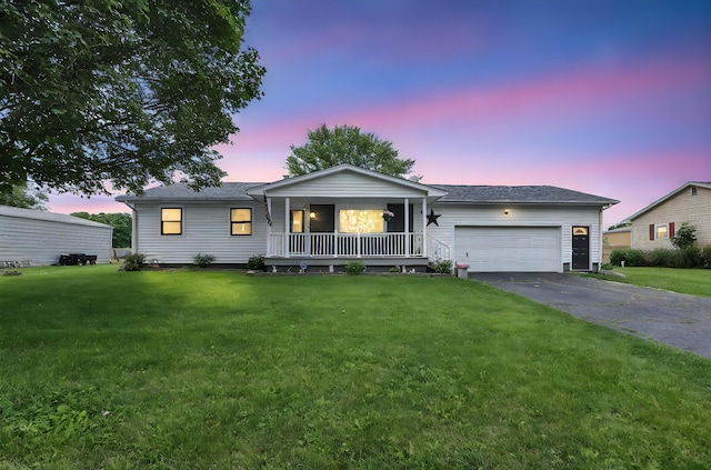 568 Swackhammer Rd, Circleville, OH 43113 - single story home featuring a porch, driveway, an attached garage, and a yard
