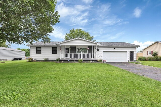 568 Swackhammer Rd, Circleville, OH 43113 - ranch-style home featuring a porch, an attached garage, asphalt driveway, and a front lawn
