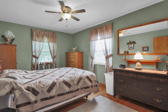 568 Swackhammer Rd, Circleville, OH 43113 - bedroom with multiple windows, wood finished floors, and a ceiling fan