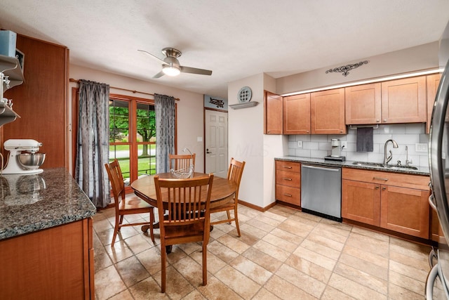 4051 Tamarack Ave, Grove City, OH 43123 - kitchen featuring stainless steel appliances, a ceiling fan, tasteful backsplash, dark stone countertops, and brown cabinetry