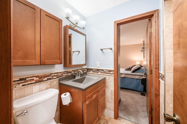 4051 Tamarack Ave, Grove City, OH 43123 - half bathroom featuring tile walls, vanity, ensuite bath, and wainscoting